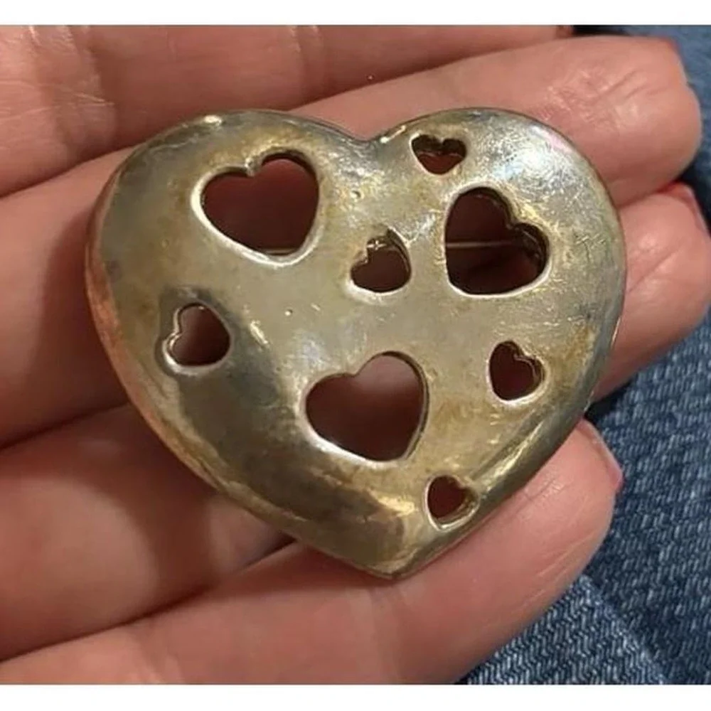 Vintage silver tone heart brooch with cutout hearts